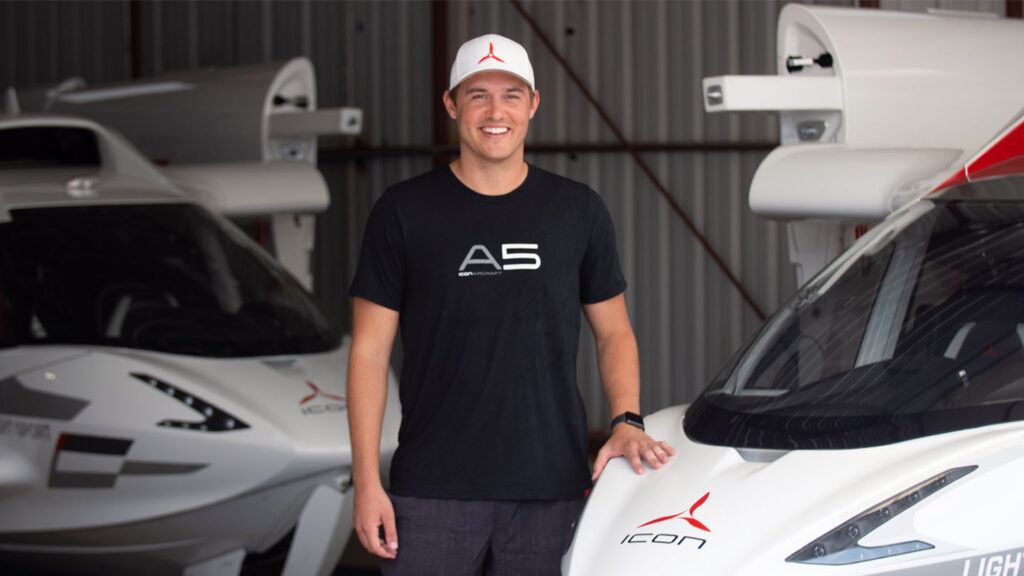 Peter Weber, "The Aviation themed Bachelor" standing next to an A5 Airplane.